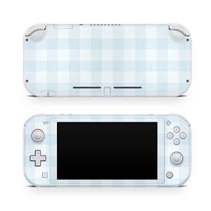May include: A white Nintendo Switch Lite console with a light blue and white checkered pattern.
