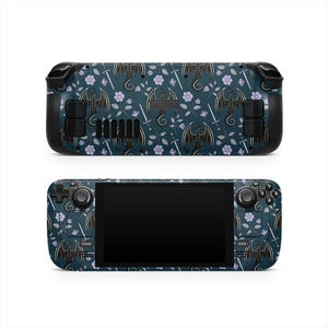 May include: A handheld gaming device with a dark teal dragon and floral pattern. The design features black dragons, swords, and purple flowers. The device has black control buttons and a black screen.
