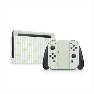 May include: A Nintendo Switch console and controllers with a light green and white striped pattern featuring bows. The controllers have black accents and buttons. The console is on a white background.