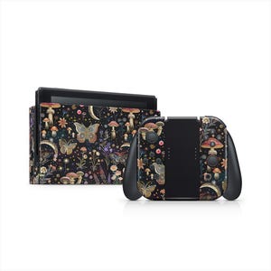 May include: A black Nintendo Switch console and controllers featuring a floral and butterfly pattern. The design includes mushrooms, flowers, and moons. The controllers are black with black buttons and a black back.