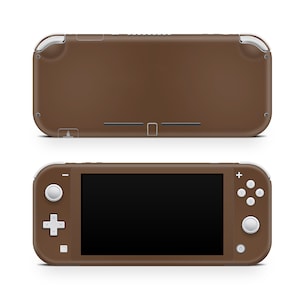 May include: A brown Nintendo Switch Lite handheld gaming console with white buttons and a black screen.