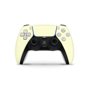 May include: A pale yellow PlayStation 5 DualSense wireless controller with black accents and white buttons. The controller has a PlayStation logo on the front.