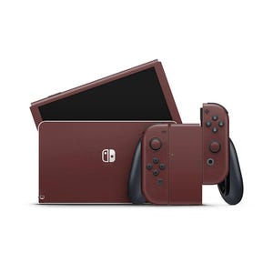 May include: A maroon Nintendo Switch console with matching Joy-Con controllers. The console is shown with the screen open, revealing a black display. The Joy-Cons are attached to the console, and the overall design is sleek and modern.