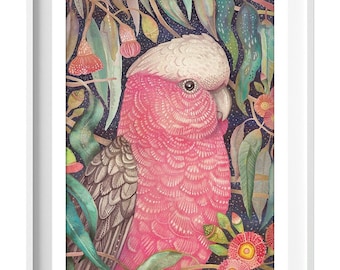 May include: A framed watercolor print featuring a pink and gray galah cockatoo amidst lush green foliage and red flowers. The artwork has a dark blue background with white speckles. The text "Wild Garden" is in the bottom left corner.