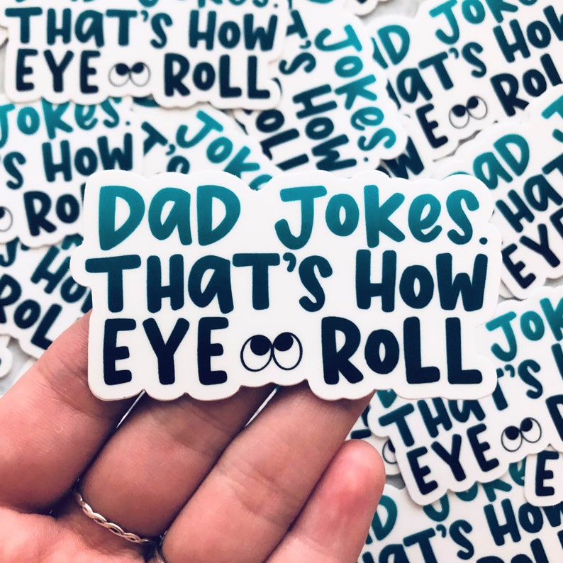 May include: A white sticker with a blue and green gradient design. The sticker says "Dad Jokes. That's how eye roll". The text is in a bold, playful font. The sticker has a pair of cartoon eyes with black pupils.