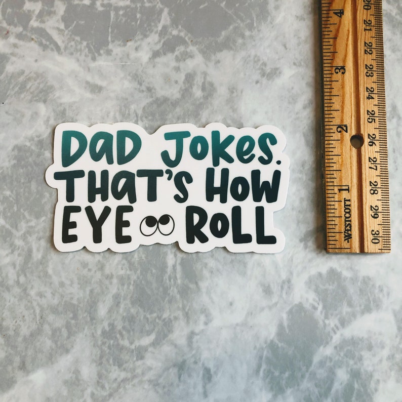 May include: A white sticker with a teal and black gradient design. The sticker says "DAD Jokes. THAT'S HOW EYE ROLL" with two black eyes with white pupils.
