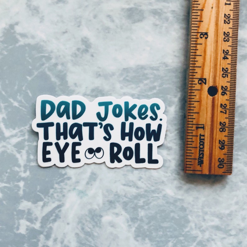 May include: White sticker with blue and teal text that reads "DAD Jokes. THAT'S HOW EYE ROLL" with two cartoon eyes in the word "EYE".