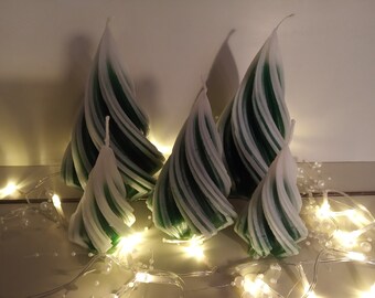 Twisted green Christmas tree candles covered in snow in three sizes (15 cm; 12 cm; 9 cm), very delicate