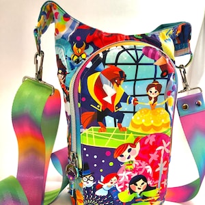May include: A colorful crossbody bag with a zippered pocket and a Disney princess theme. The bag features characters like Belle, Beast, and Mulan. The strap is rainbow-colored.