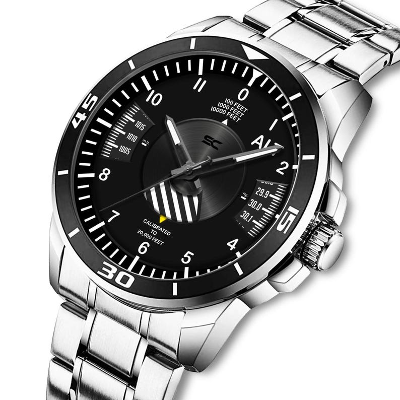 May include: A stainless steel wristwatch with a black dial and a black bezel. The watch face features white numerals, hands, and indicators, including altitude and pressure readings. The watch band is made of stainless steel.