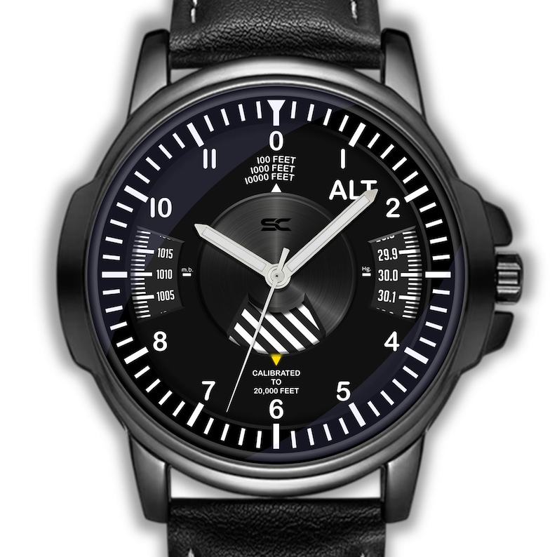 May include: Black wristwatch with a black dial featuring white markings and hands. The watch face includes altimeter readings, with text indicating altitude in feet and pressure in Hg. The watch has a black leather band.