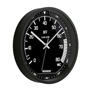 May include: Black analog clock with white markings and hands. The clock face displays numbers, a gauge, and the text "16V" and "Renault". The clock has a black bezel and a modern design.