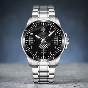May include: A silver wristwatch with a black face and a silver band. The watch face has white markings and hands, with the numbers 0, 5, 10, 15, 30, and 45 visible. The watch has a rotating bezel and a crown on the side.