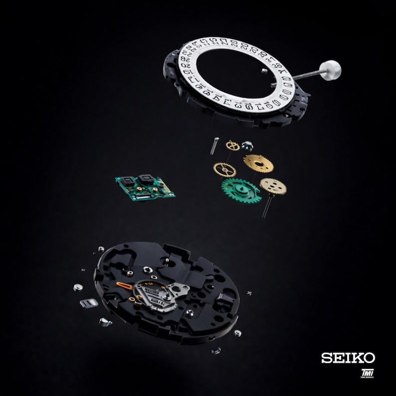 May include: An exploded view of a Seiko watch mechanism, showcasing its intricate components. The image features a black background with various parts suspended in mid-air, including gears, a circuit board, and the date dial. The Seiko logo is visible at the bottom right.