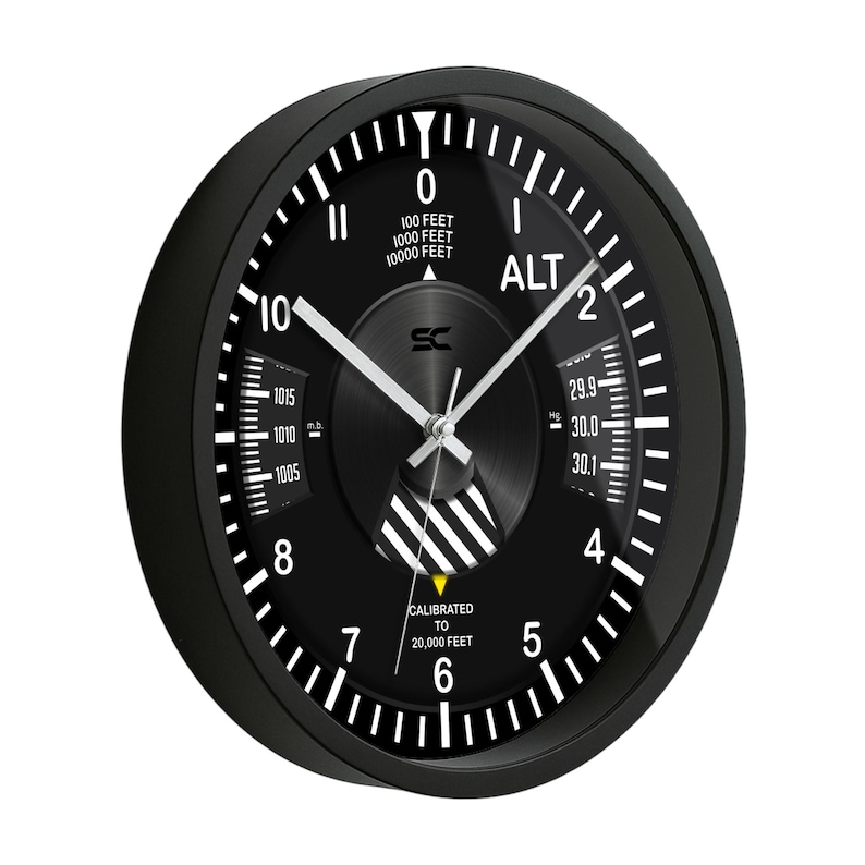 May include: Black analog wall clock with white markings and hands. The clock face features the word "ALT" and measurements in feet. The clock is calibrated to 20,000 feet.