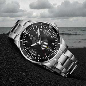 May include: A stainless steel wristwatch with a black dial and a silver band. The watch face features white numerals, a rotating bezel, and a second hand. The watch is displayed on a dark surface with a cloudy sky and ocean in the background.