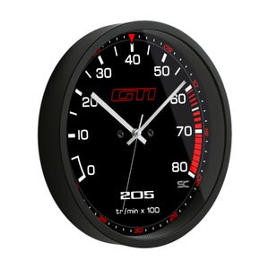 May include: Black round wall clock with a speedometer design. The clock face features white numbers, a red GTI logo, and red accents. The clock hands are white, and the text "205 tr/min x 100" is visible.