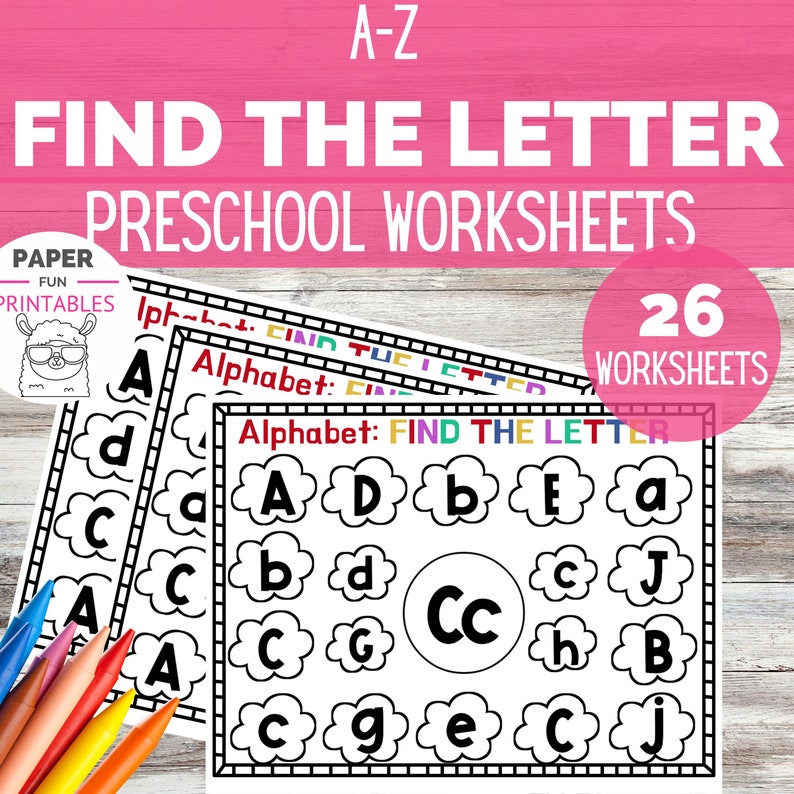 May include: A stack of preschool worksheets with the text "FIND THE LETTER" and "PRESCHOOL WORKSHEETS". The worksheets feature the alphabet with letters inside cloud shapes. A pink circle indicates "26 WORKSHEETS". Colored pencils are visible.