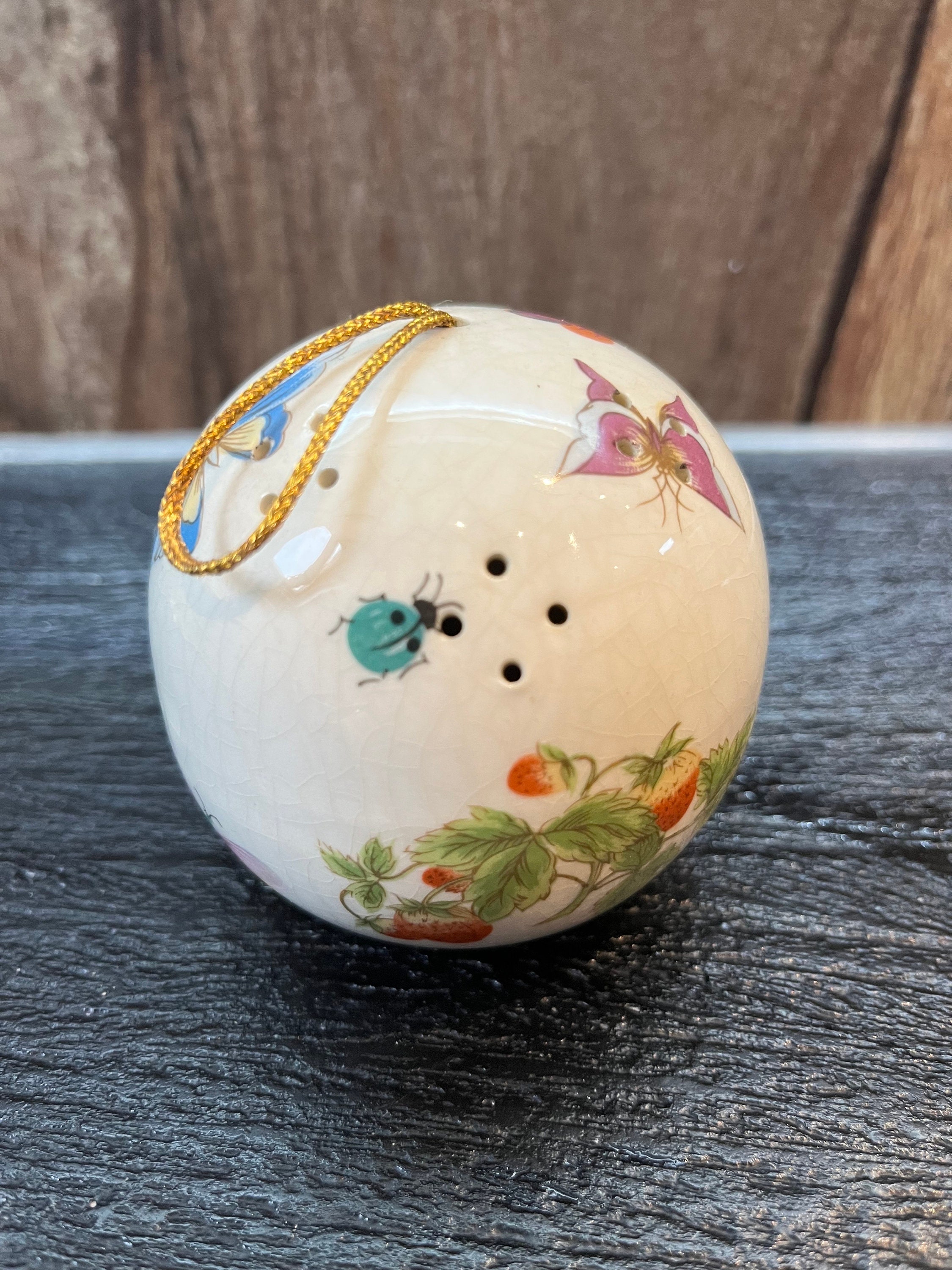 ceramic pomander filled with perfumed. Imagine it’s 1950s Chinese export with butterflies and flowers