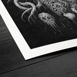 May include: Monochrome art print depicting a detailed, abstract creature with tentacles and multiple eyes. The artwork is set against a dark background with a white border, creating a striking contrast.