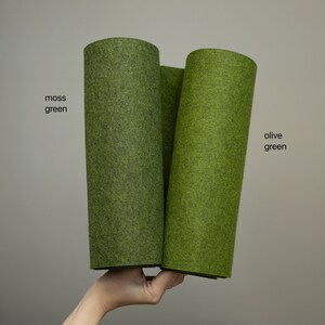 May include: Two rolls of felt fabric, one in moss green and one in olive green.