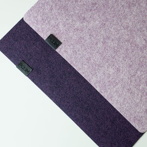 May include: Two pieces of fabric, one purple and one dark purple, with the word "PLUM" printed on each.