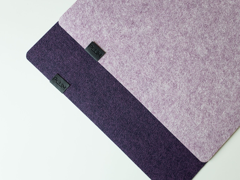 May include: Two pieces of fabric, one purple and one dark purple, with the word "PLUM" printed on each.