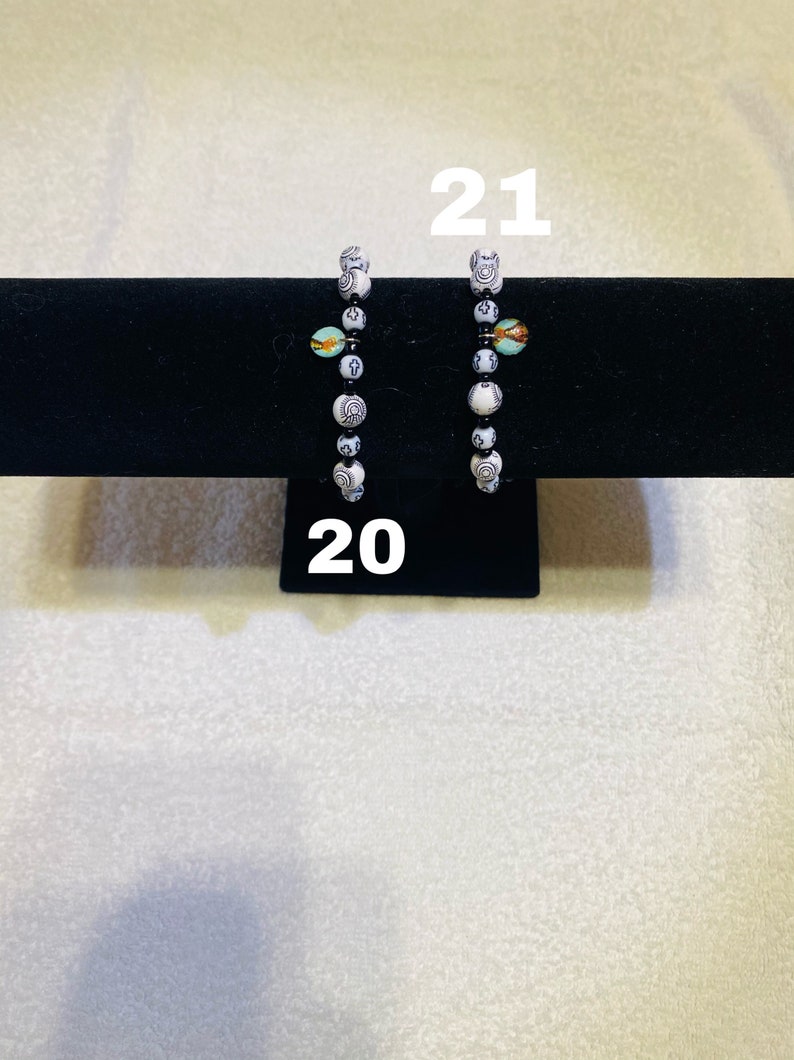 Red And Black Bracelets With Charms