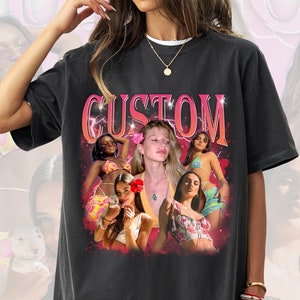 May include: Black t-shirt with a vintage-style graphic print featuring a group of women in various poses. The graphic includes the word "CUSTOM" in pink letters with lightning bolts.