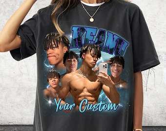 May include: A black t-shirt with a vintage-style graphic featuring a collage of photos of a young man with the text "KEANU" and "Your Custom" printed in blue.