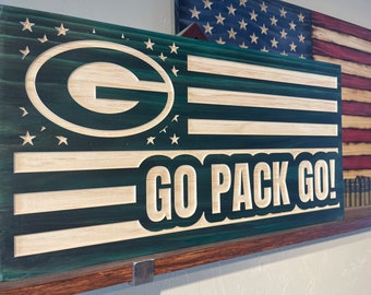May include: Green and white wooden sign with the Green Bay Packers logo and the words "GO PACK GO!"