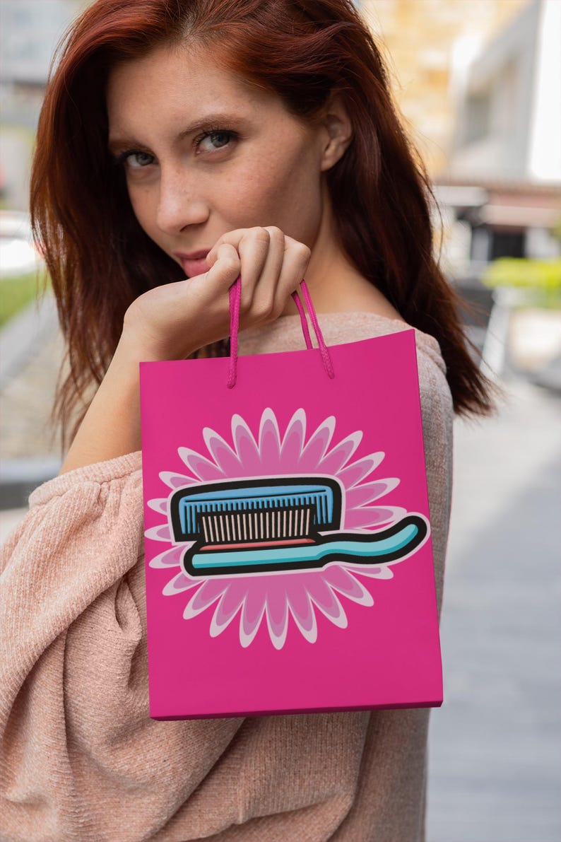 May include: A pink shopping bag with a white and blue toothbrush graphic on a pink flower design. The bag has white handles.