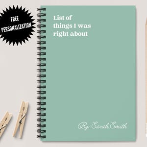 May include: A light green spiral bound notebook with the text "List of things I was right about" and "By Sarah Smith" on the front cover.