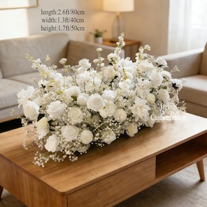 May include: A display of white roses, dahlias, and baby's breath in a rectangular shape on a wooden coffee table. The floral arrangement is 80cm long, 40cm wide, and 50cm high. The table has a drawer. The text "Jackon Customization" is visible.
