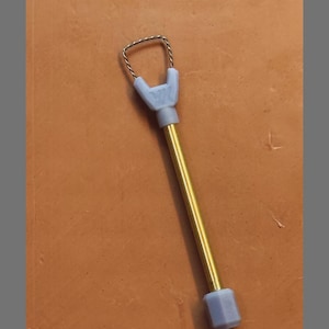 May include: A mini wire rake tool with a square type design. The tool has a silver wire rake head, a light blue handle, and a gold-colored shaft. The text "YK MINI WIRE RAKE TOOL" and "SQUARE TYPE" are visible.