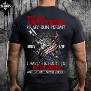 May include: A black short-sleeved t-shirt featuring a graphic print on the back. The design includes a rifle, a stylized American flag, and text that reads: THE 2ND AMENDMENT IS MY GUN PERMIT SINCE 1791 I HAVE THE RIGHT TO BEAR ARMS AND THE DATE NEVER EXPIRES.