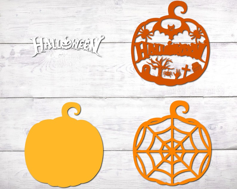 May include: Four orange pumpkin-shaped Halloween decorations. Two are plain, one has a spiderweb design, and one has a graveyard scene with the word "Halloween" written inside.