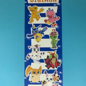 May include: A rectangular bookmark featuring the word "DIGIMON" in orange letters at the top. The bookmark has a blue background with white stripes and cartoon characters in various colors.