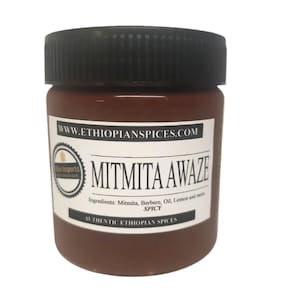 May include: A jar of Mitmita Awaze, an authentic Ethiopian spice blend. The jar is brown with a black lid and a white label with text. The label includes the ingredients and the website address.