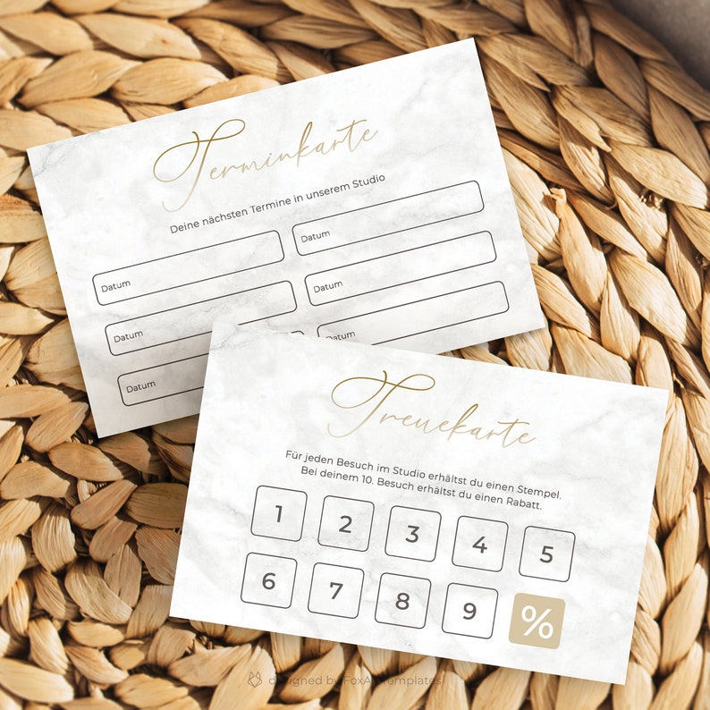 May include: White card with a gold inscription that says "Terminkarte" and "Treuekarte". The card has a marble pattern and is divided into two sections. The top section has a list of dates with blank spaces for writing in the dates. The bottom section has a grid of numbers 1 through 9 and a percentage symbol. The text on the card says "Deine n&auml;chsten Termine in unserem Studio" and "F&uuml;r jeden Besuch im Studio erh&auml;ltst du einen Stempel. Bei deinem 10. Besuch erh&auml;ltst du einen Rabatt."