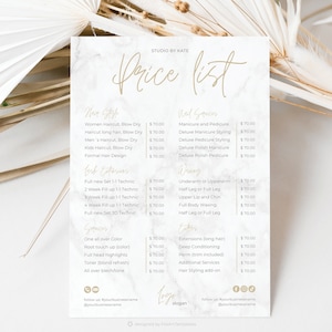 Op de afbeelding: Een prijslijst van Studio by Kate met diensten zoals haar knippen, manicures, wimper extensions, waxen en haarstyling. De tekst is goudkleurig op een marmeren achtergrond.
