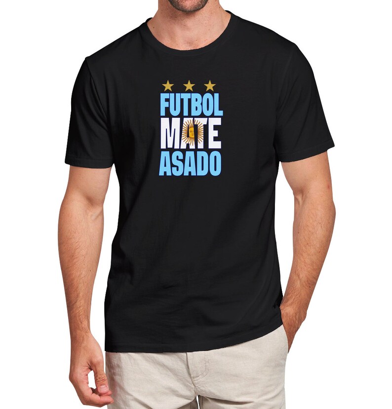 May include: Black t-shirt with a blue and white graphic that says "FUTBOL MATE ASADO" with three gold stars above the text.