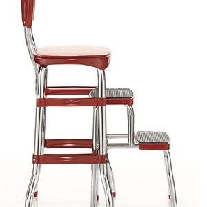 May include: Red step stool with a chrome frame and a padded seat. The stool has two steps and is designed to be used in the kitchen.