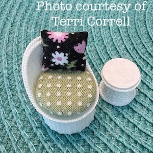 May include: Miniature white wicker chair with a green polka-dot seat cushion and a black floral pillow. A small white side table is next to the chair. The text "Photo courtesy of Terri Correll" is in the background.