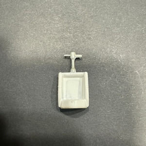 May include: A white plastic urinal with a silver metal flush handle.