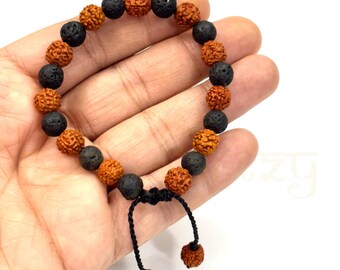 May include: A brown and black beaded bracelet with a knotted closure. The bracelet is made with round beads and has a simple design.