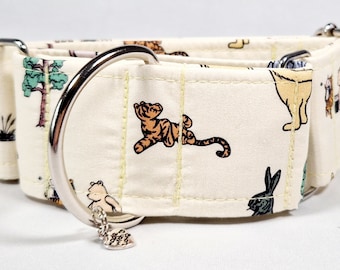 May include: A white fabric dog collar with a silver buckle and a silver ring. The collar has a Winnie the Pooh themed print with characters like Tigger, Piglet, and Eeyore. The collar has a small silver charm attached to it.