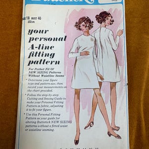 May include: Vintage Butterick sewing pattern envelope. The cover features illustrations of women in white A-line dresses. Text includes "your personal A-line fitting pattern" and size details. The envelope is blue and white.