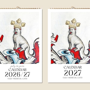 May include: Two calendars featuring a medieval-style illustration of a white cat wearing a gold crown. The calendars are labeled "CALENDAR 2026/27" and "CALENDAR 2027" with the text "UGLY MEDIEVAL CATS" below the dates. The illustrations have red, white, and blue accents.