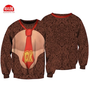 May include: Brown sweatshirt featuring a design inspired by a video game character. The front displays a tan chest, a red tie with "DK" in gold letters, and brown fur. The back of the sweatshirt is solid brown fur. The brand logo "SILHOUETTE FUN" is in the upper left corner.